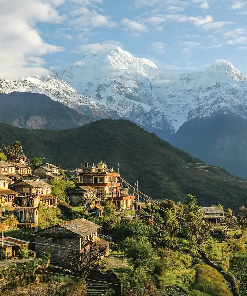 Himalayan village beneath the snow-covered Annapurna mountains