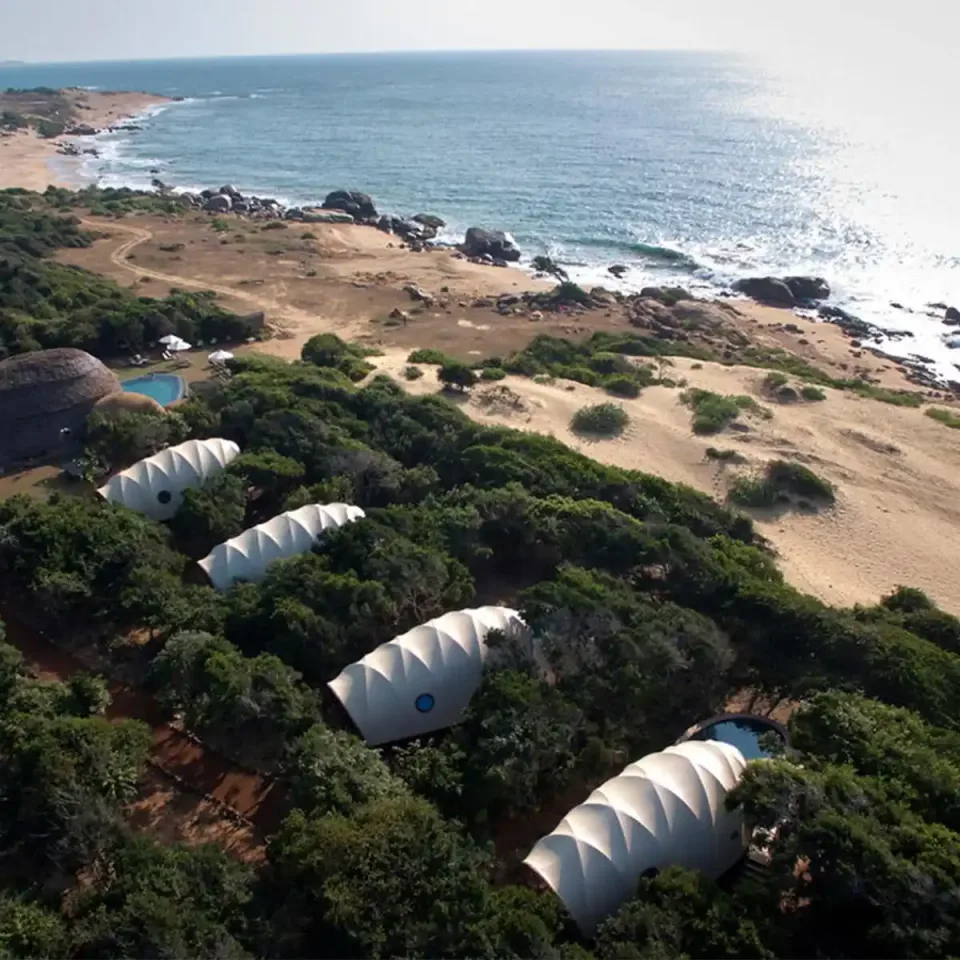 Aerial view of a luxury tented lodge beside Sri Lanka coastline