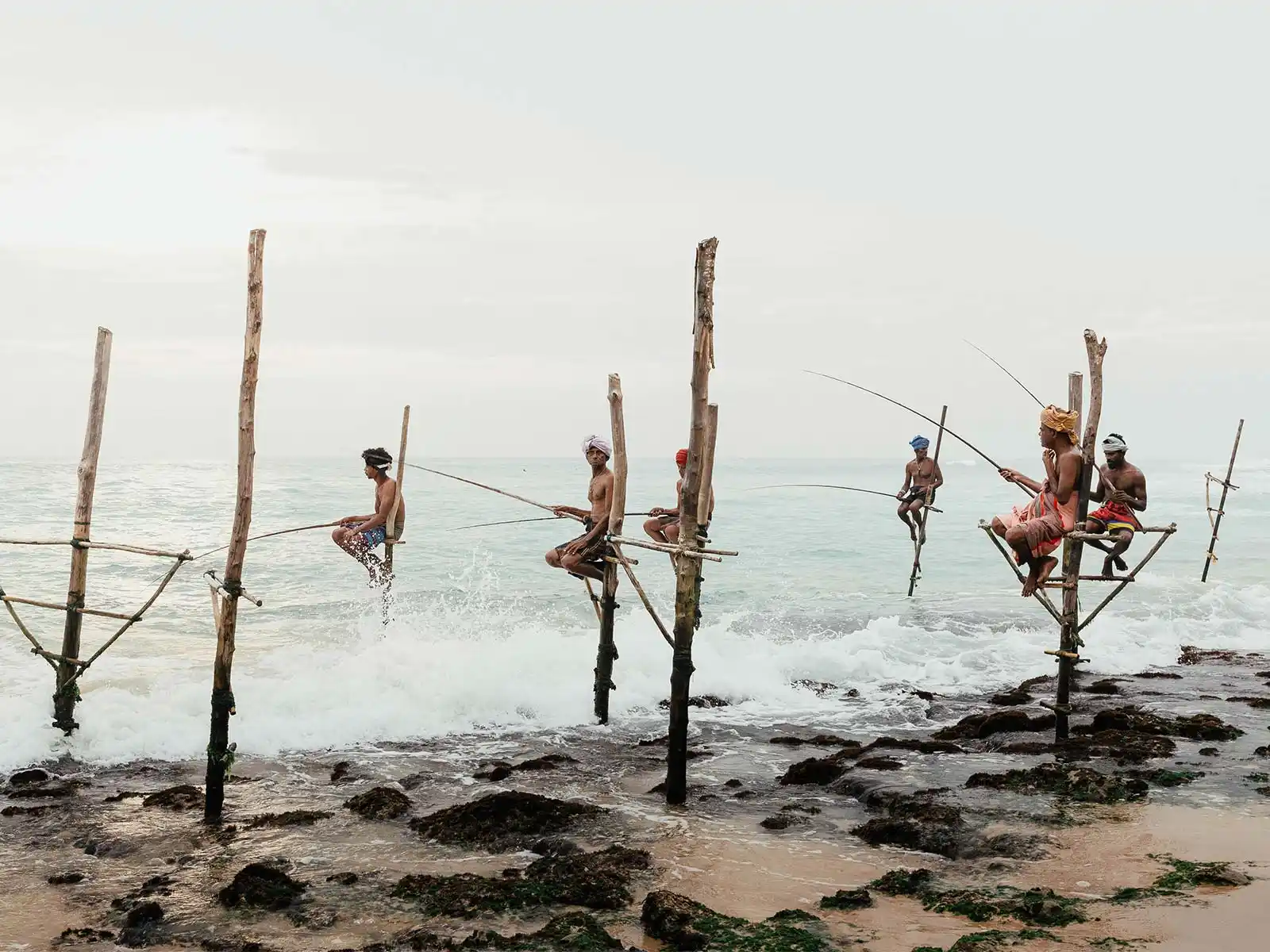 Traditional stilt fishermen at sunset in southern Sri Lanka