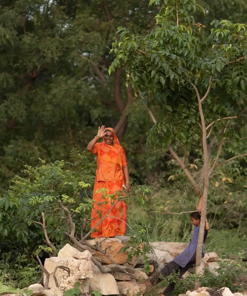Woman greeting travellers in a rural part of India