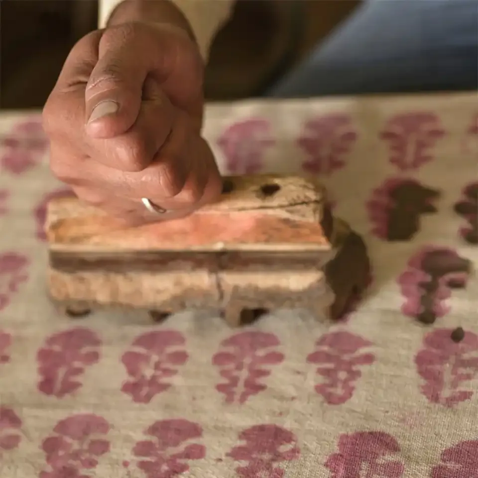 Artisan demonstrating traditional Indian hand block printing
