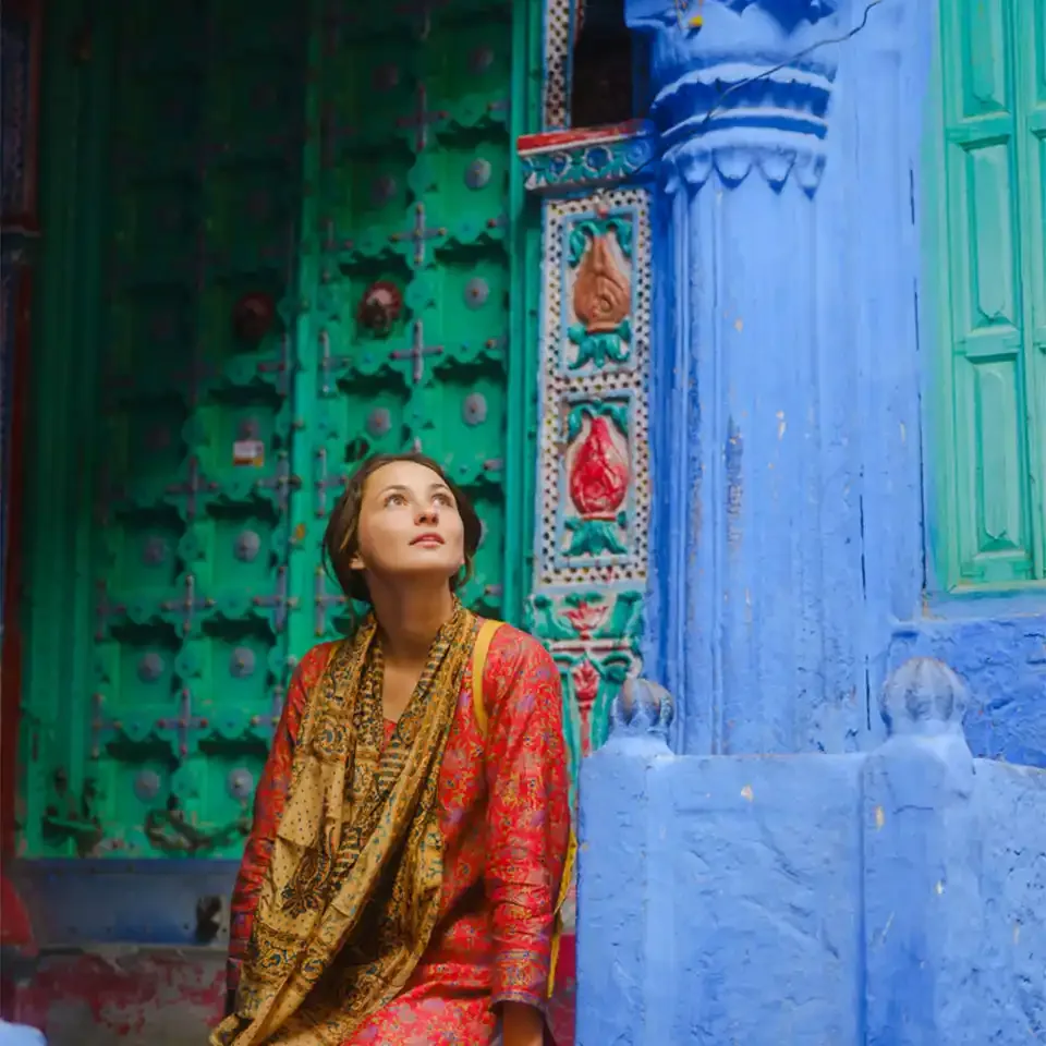 Solo woman exploring a colourful historic street in India