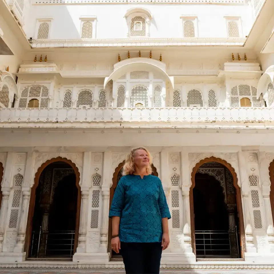 Solo traveller with a specialist guide at a white palace in India