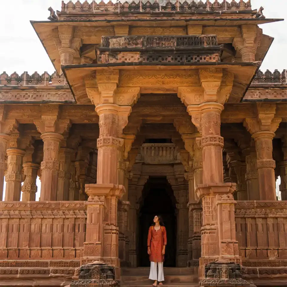 Solo traveller visiting a historic stone temple in India
