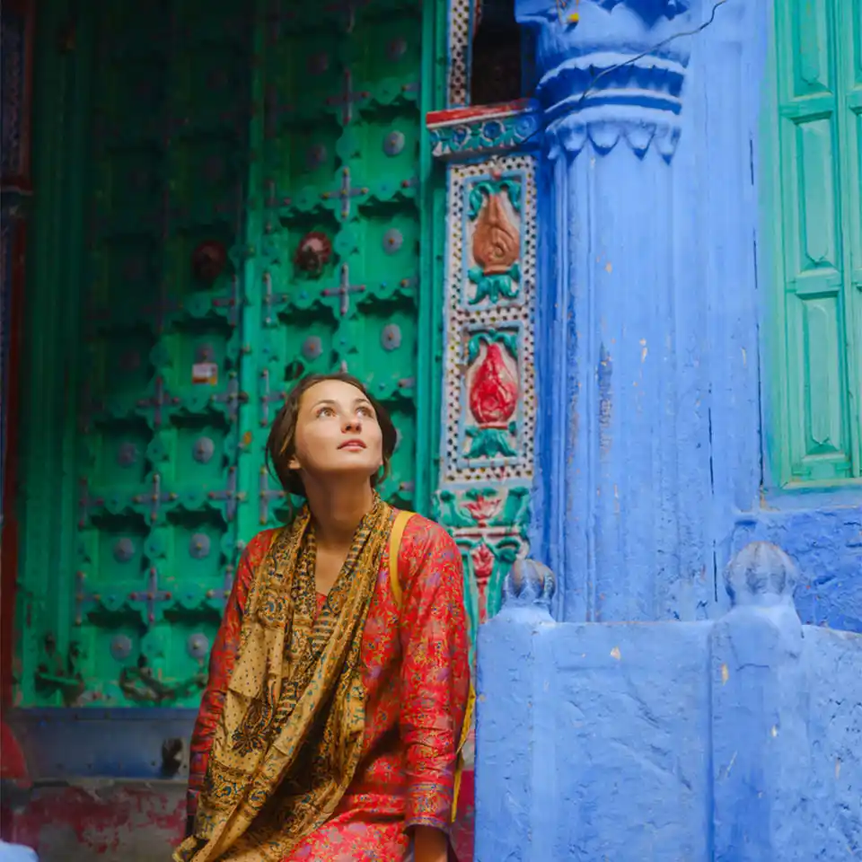 Solo woman exploring a colourful historic street in India